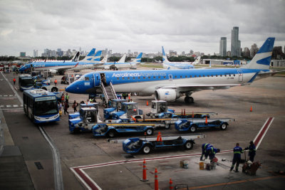 Passengers descend from an Aerolineas Argentinas Embraer 190 aircraft, at the Aeroparque Jorge Newbery airport