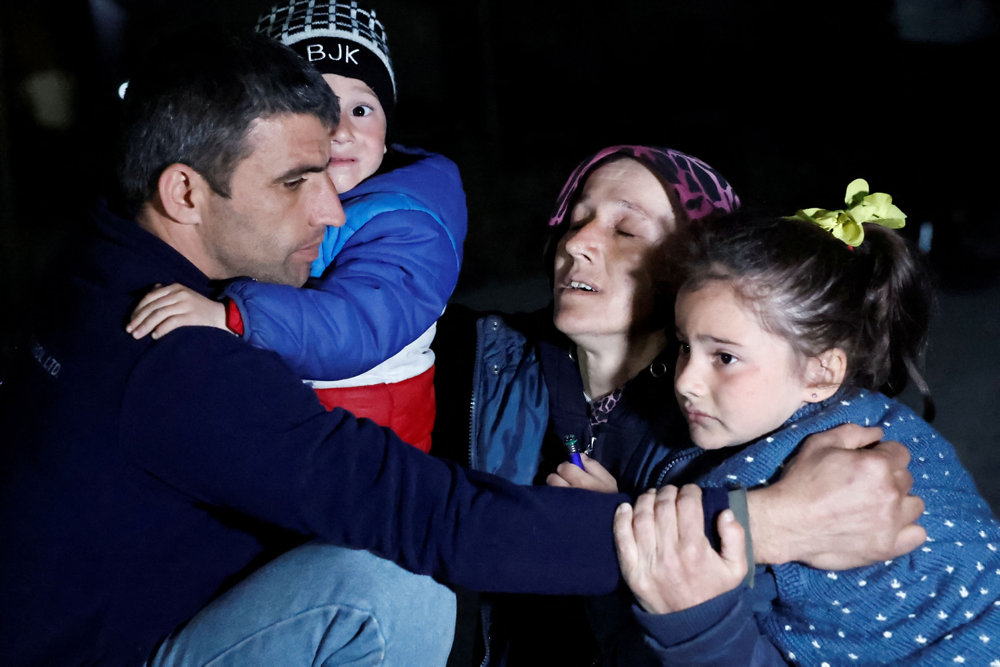 People react after a quake in Antakya in Hatay province, Turkey