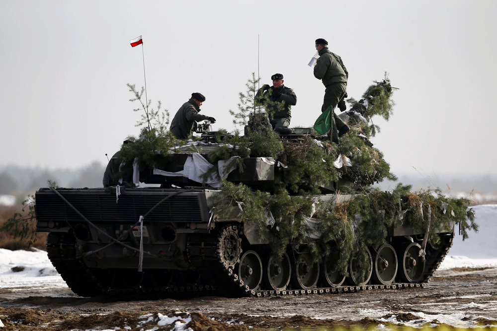 FILE PHOTO: Polish army soldiers atop their Leopard 2A4 tank after live firing exercise in Zagan