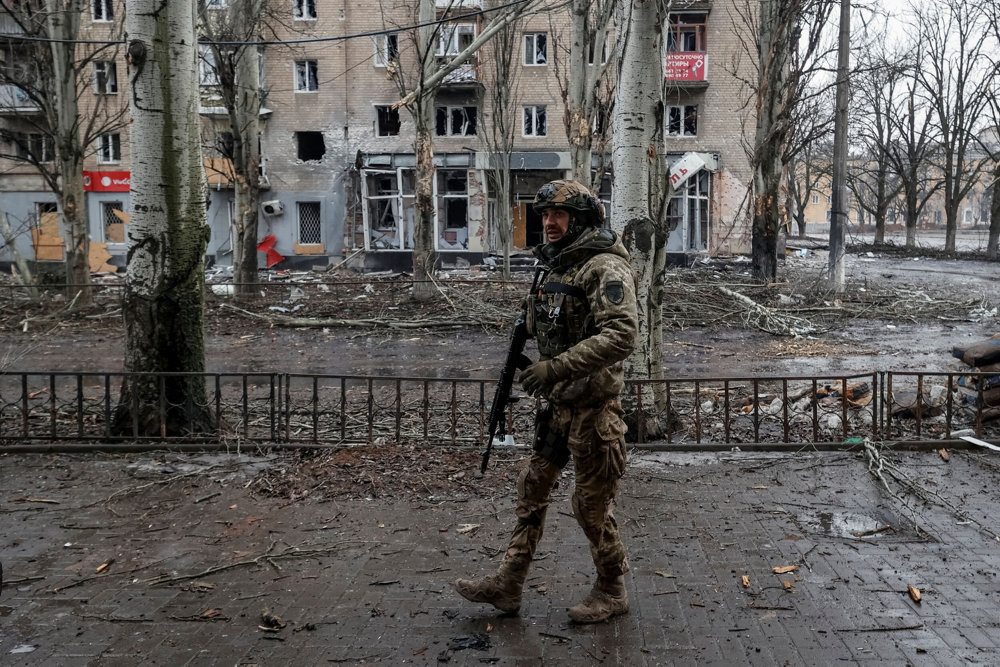 A Ukrainian serviceman walks an empty street in the front line city of Bakhmut