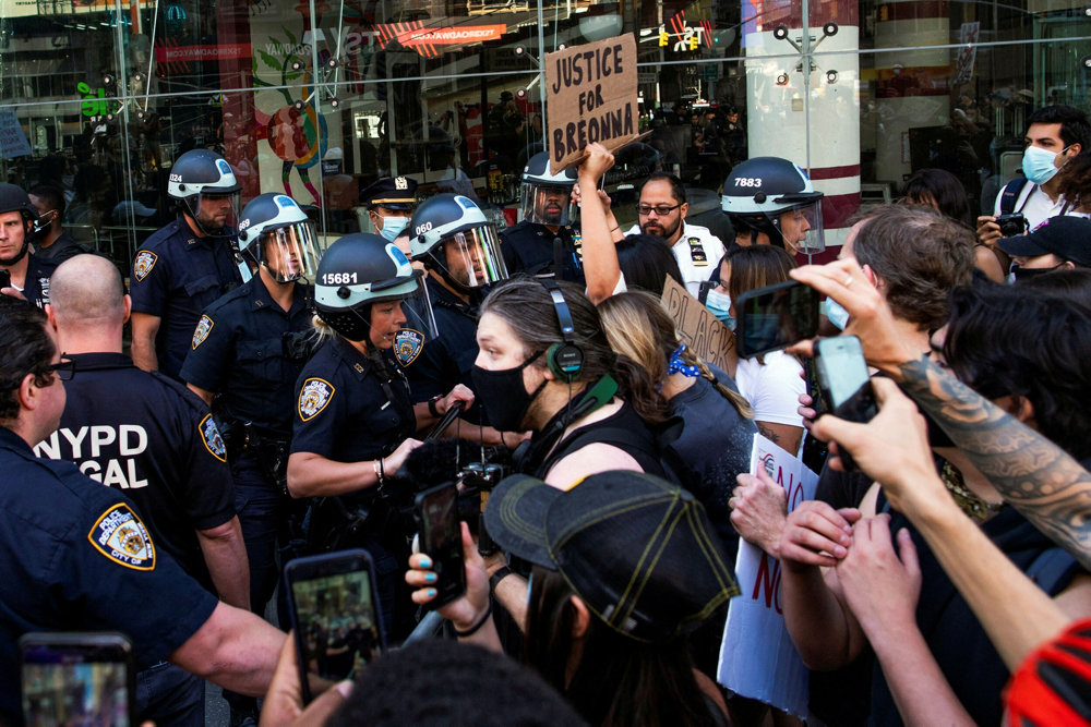 FILE PHOTO: Demonstrators scuffle with NYPD police officers as they try to march trough Times Square during a protest against racial inequality in the aftermath of the death in Minneapolis police custody of George Floyd, in New York City, New York