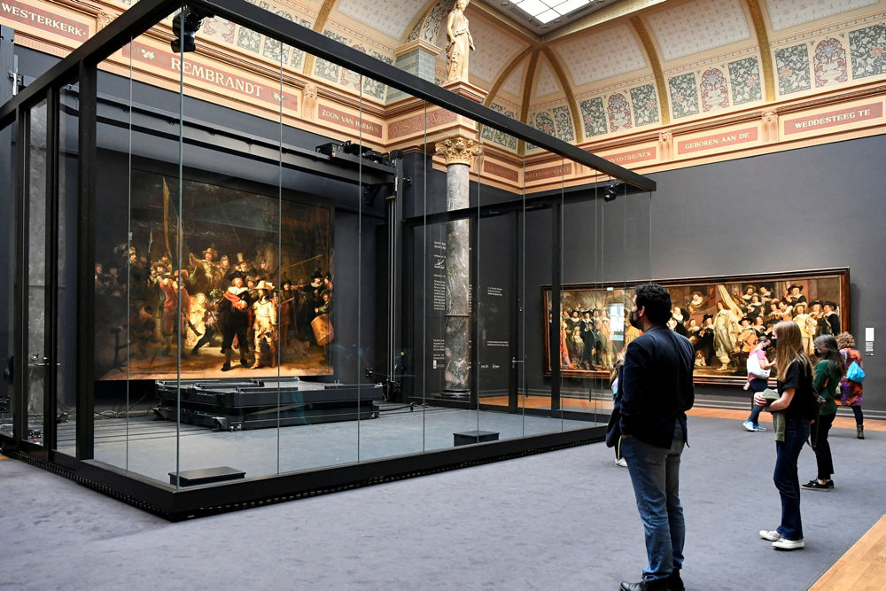 FILE PHOTO: People look at Rembrandt''s famed Night Watch at Rijksmuseum in Amsterdam