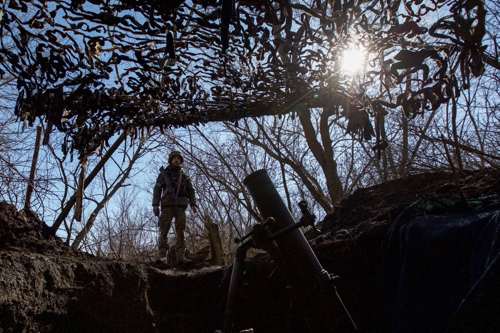 Ukrainian serviceman stands near a mortar on a front line near the front line city of Bakhmut