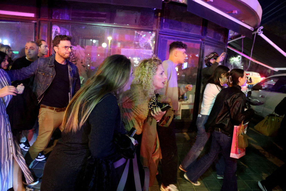 People react in the aftermath of a shooting attack in central Tel Aviv