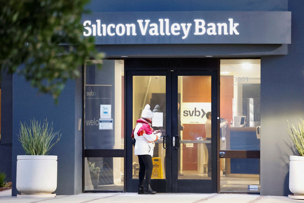 A customer takes a photograph of a newly posted letter at the Silicon Valley Bank headquarters in Santa Clara