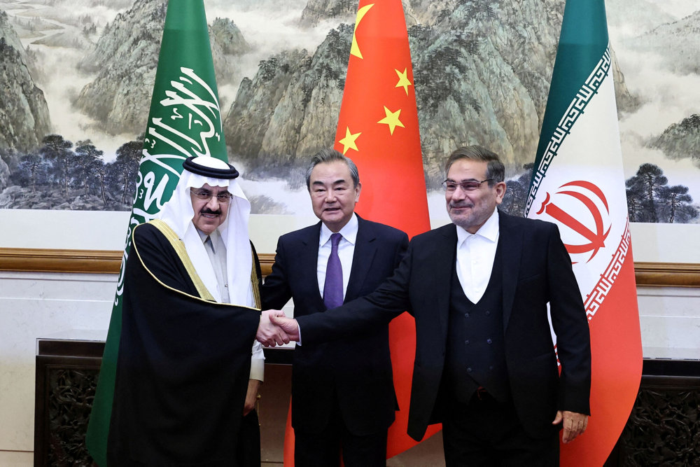 FILE PHOTO: China''s director of the Office of the Central Foreign Affairs Commission Wang Yi, Ali Shamkhani, the secretary of Iran''s Supreme National Security Council and Saudi national security adviser Musaad bin Mohammed Al Aiban meet in Beijing