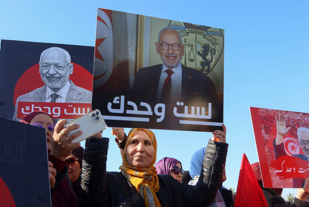 Supporters of Rached Ghannouchi, head of the Islamist Ennahda party gather outside a court before his arrival for questioning