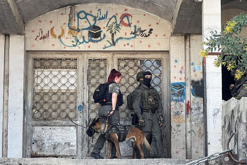 Israeli security force members search and patrol the area following a shooting incident in East Jerusalem