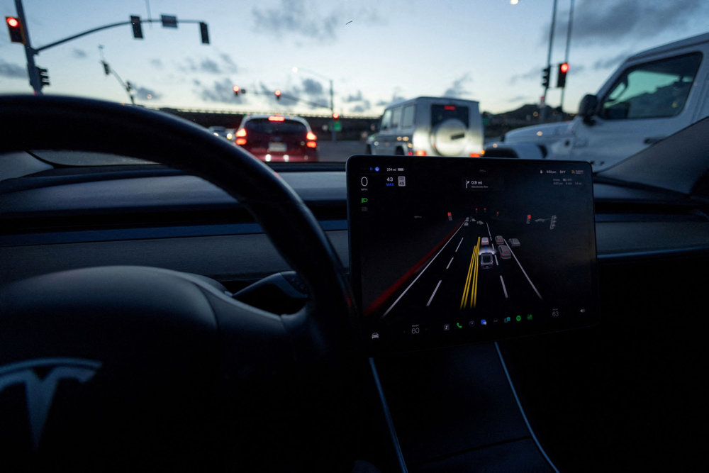 FILE PHOTO: Tesla Model 3 uses autopilot FSD beta to navigate city streets in California