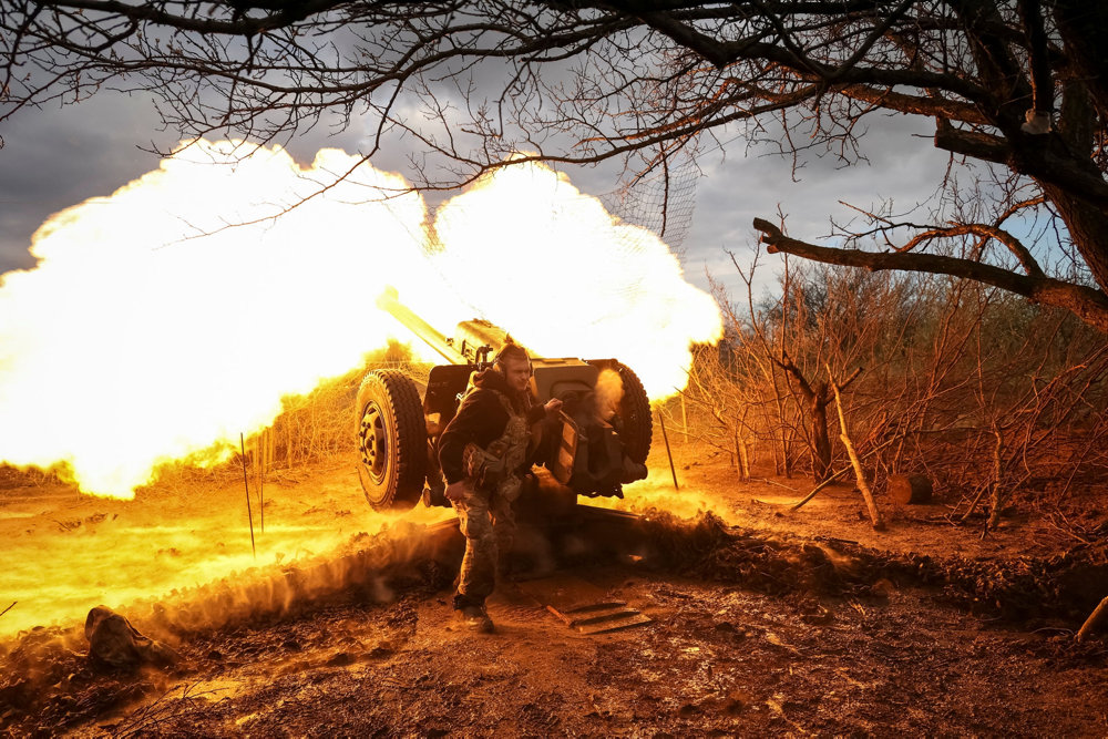 Ukrainian service members fire a howitzer D30 at a front line near the city of Bakhmut