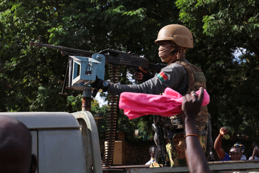 FILE PHOTO: New junta''s soldiers stand guard in an armoured vehicle in Ouagadougou