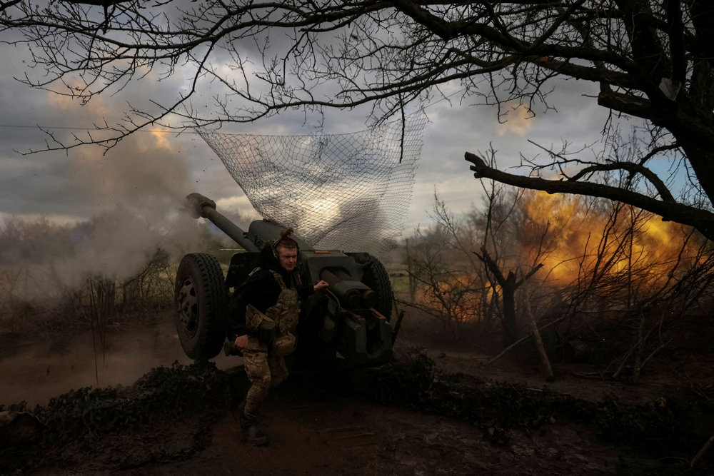 FILE PHOTO: Ukrainian service members fire a howitzer D30 at a front line near the city of Bakhmut