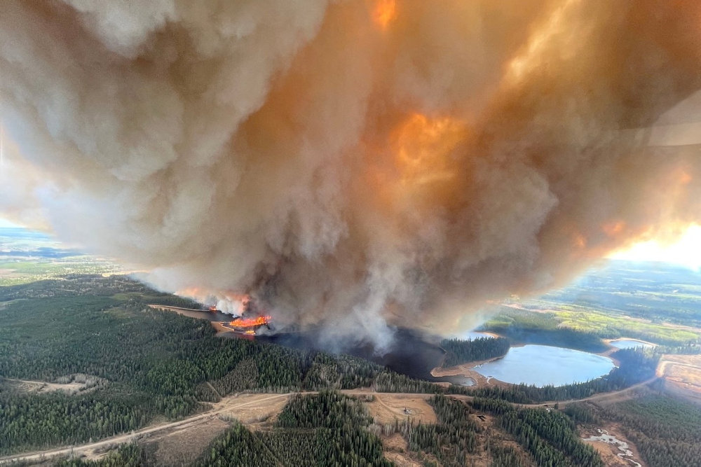 Smoke column rises from wildfire EWF031 near Lodgepole