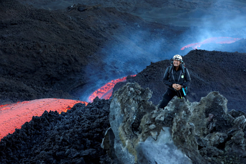 Long streams of red-hot lava flow down the southeast crater of Mount Etna, Europe''s tallest and most active volcano