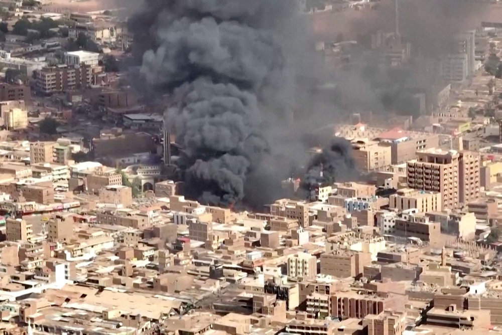 An aerial view of the black smoke and flames at a market in Omdurman