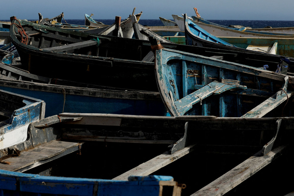 FILE PHOTO: Dozens of wooden boats used by migrants to reach the Canary Islands are seen in the Port of Arinaga