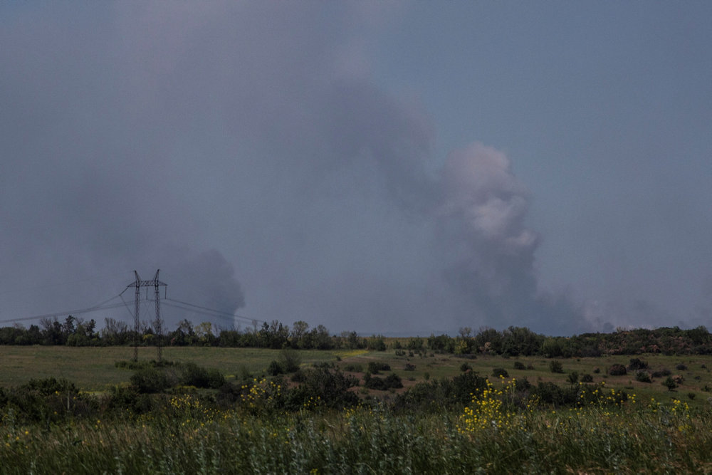 Smoke rises after a shilling near a frontline in Donetsk region