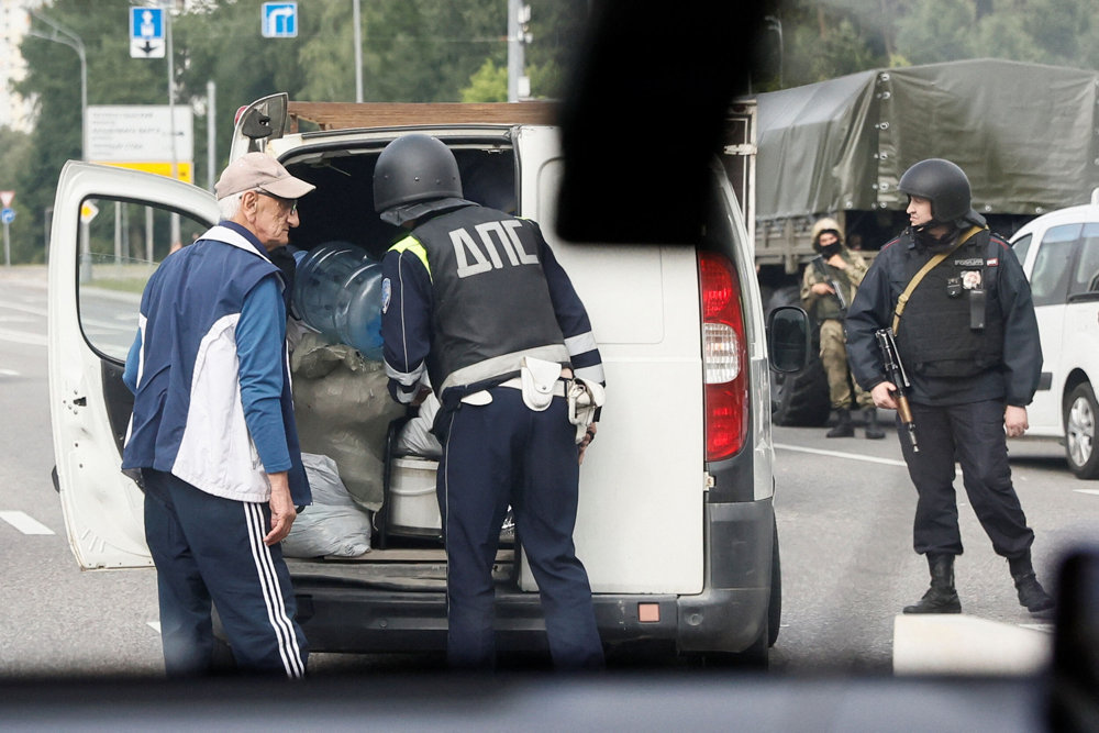 Law enforcement officers check a car on a checkpoint in Moscow