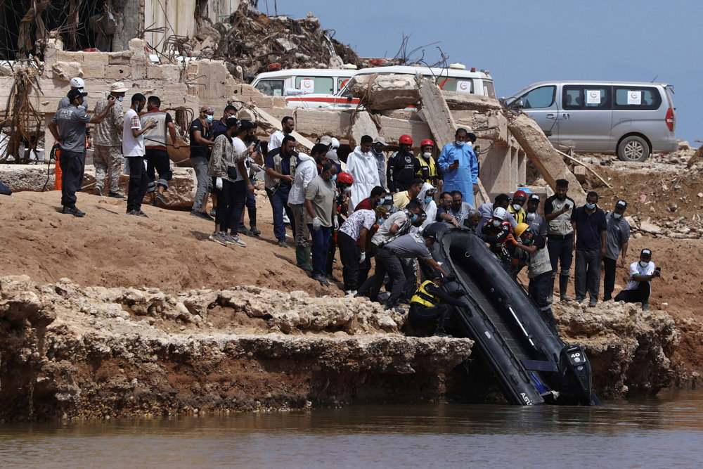 United Arab Emirates search and rescue personnel drop in a boat to carry out a search mission for dead bodies stranded at sea following floods in Derna