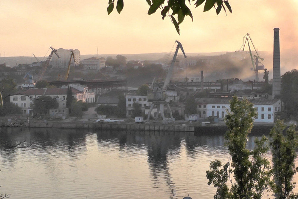 Smoke rises from the shipyard that was reportedly hit by Ukrainian missile attack in Sevastopol