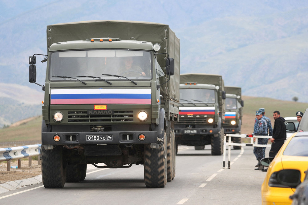 FILE PHOTO: Vehicles of Russian peacekeepers leaving Nagorno-Karabakh region pass an Armenian checkpoint near Kornidzor