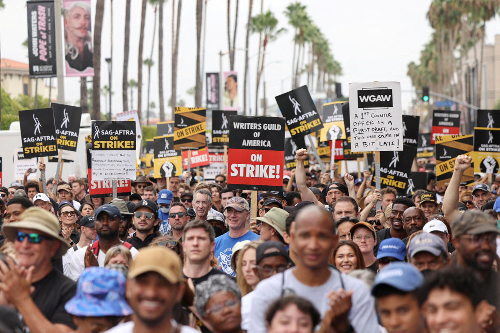 FILE PHOTO: SAG-AFTRA actors and Writers Guild of America (WGA) writers rally during their ongoing strike in Los Angeles