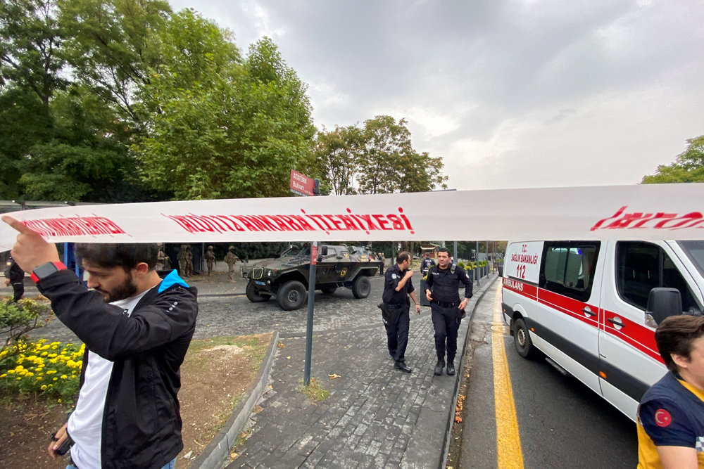 Police officers secure the area following a bomb attack in Ankara