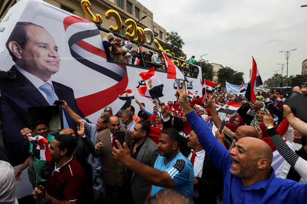 Supports of al-Sisi attend a rally to back his candidacy in the presidential elections, in Giza