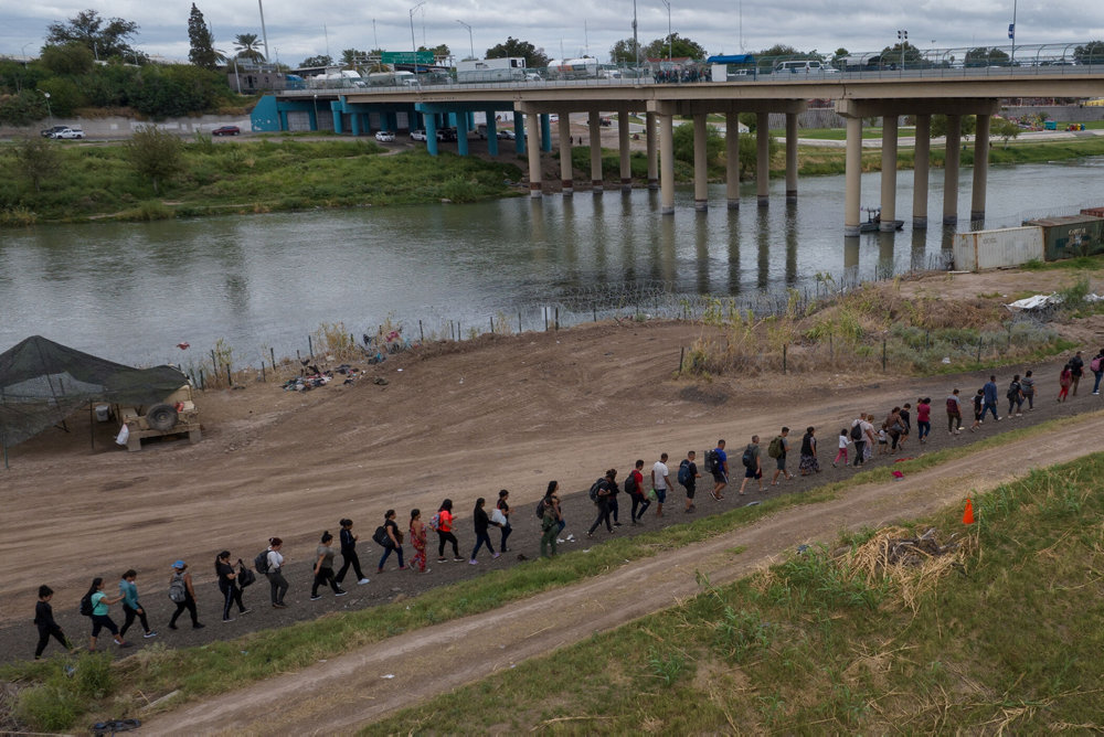 Migrants from Venezuela surrender along bank of Rio Grande river in Eagle Pass