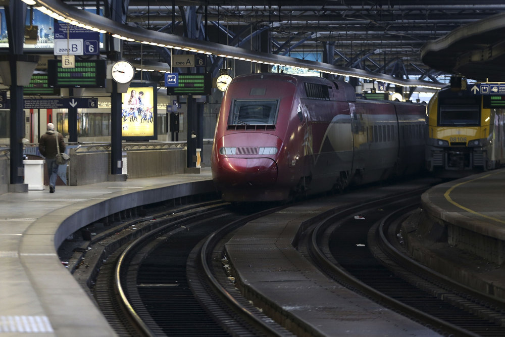 A man walks past a Thalys train on an empty platform at Midi/Zuid railway station in Brussels during a nationwide strike