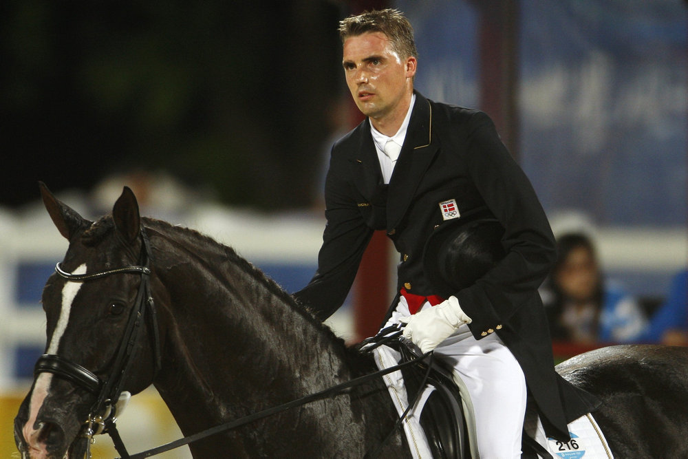 Helgstrand riding Don Schufro reacts after competing in the equestrian dressage individual grand prix special competition at the Beijing 2008 Olympic Games in Hongkong