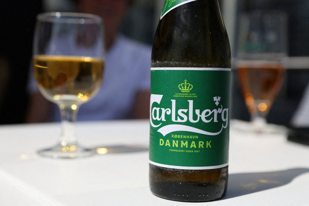 FILE PHOTO: A Carlsberg beer sits on a table in a restaurant in Copenhagen