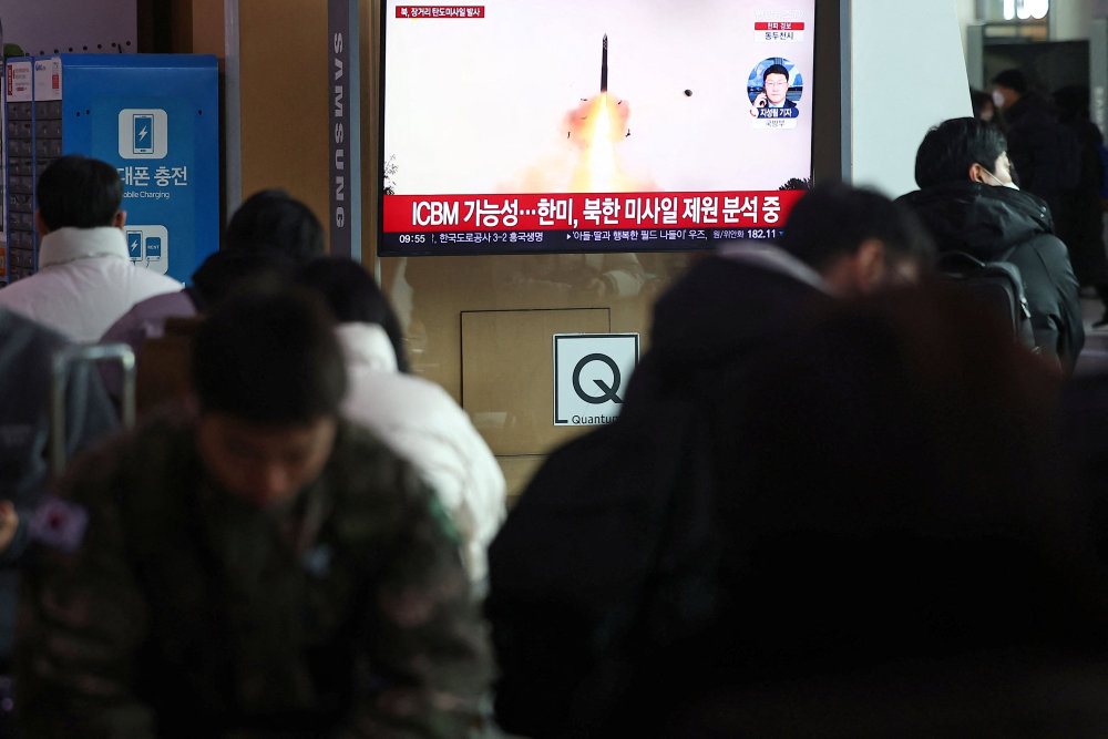 People watch a TV broadcasting a news report on North Korea firing what appeared to be a long-range ballistic missile, at a railway station in Seoul