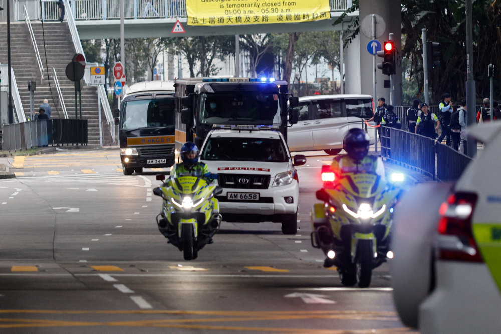A motorcade carries media mogul Jimmy Lai, founder of Apple Daily, back to Lai Chi Kok Reception Centre after the first day of his national security trial in Hong Kong